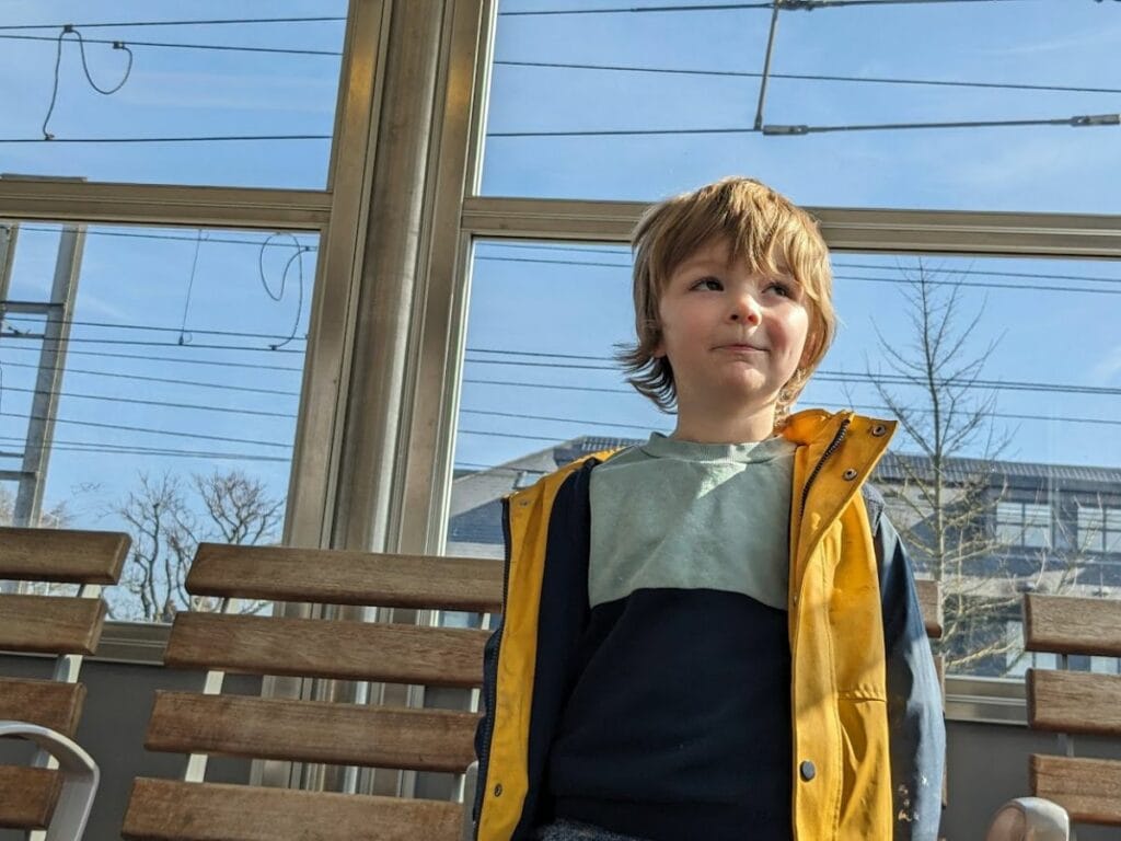 Oliver waiting at a train station.