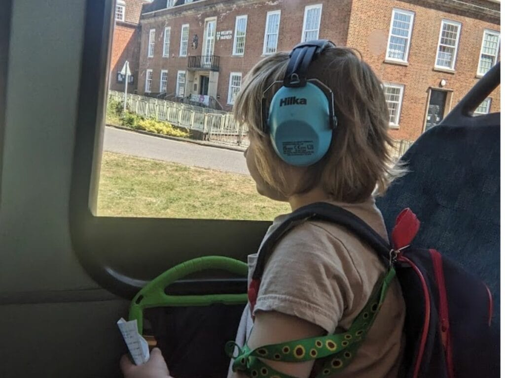 Oliver sitting on a bus looking out the window.